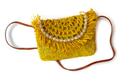 Primrose Handwoven Palm Clutch with Natural Shells with strap shown
