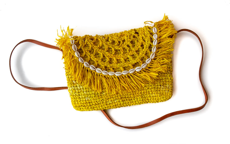 Primrose Yellow Handwoven Palm Clutch with Natural Shells with strap shown