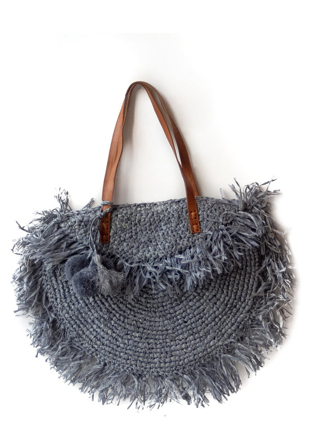 Storm gray raffia beach bag with leather strap and fringe. 