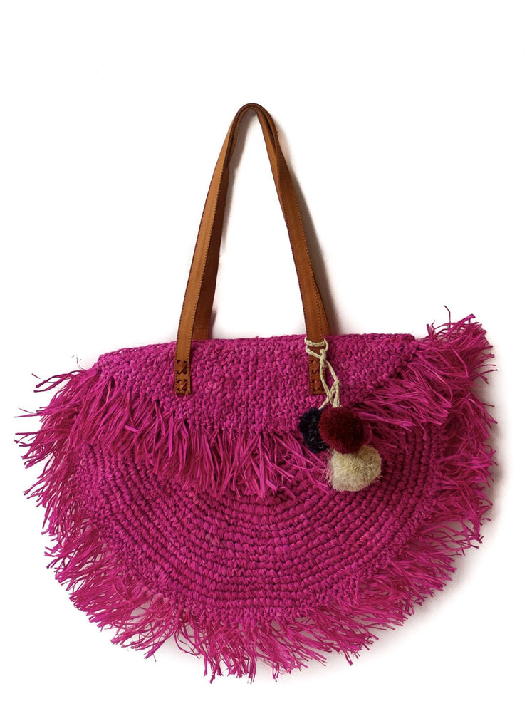 Hot pink raffia beach bag with leather strap.